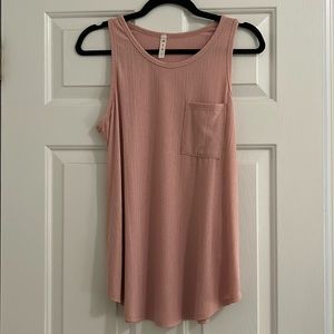 This is a lightweight pink tank top, size small from MTS, and only worn once!